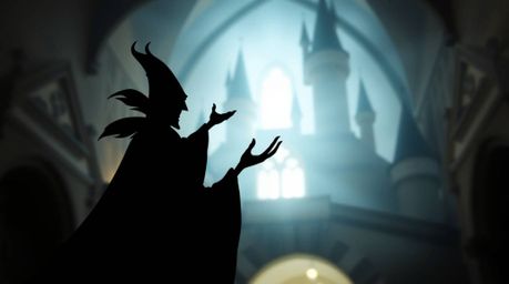 A captivating long exposure photograph depicts a classic Disney villain silhouetted against an old castle. The image boasts