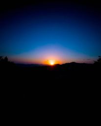 Immerse yourself in a serene Zen garden reimagined with dramatic chiaroscuro lighting during a cool-toned sunset. This powerf