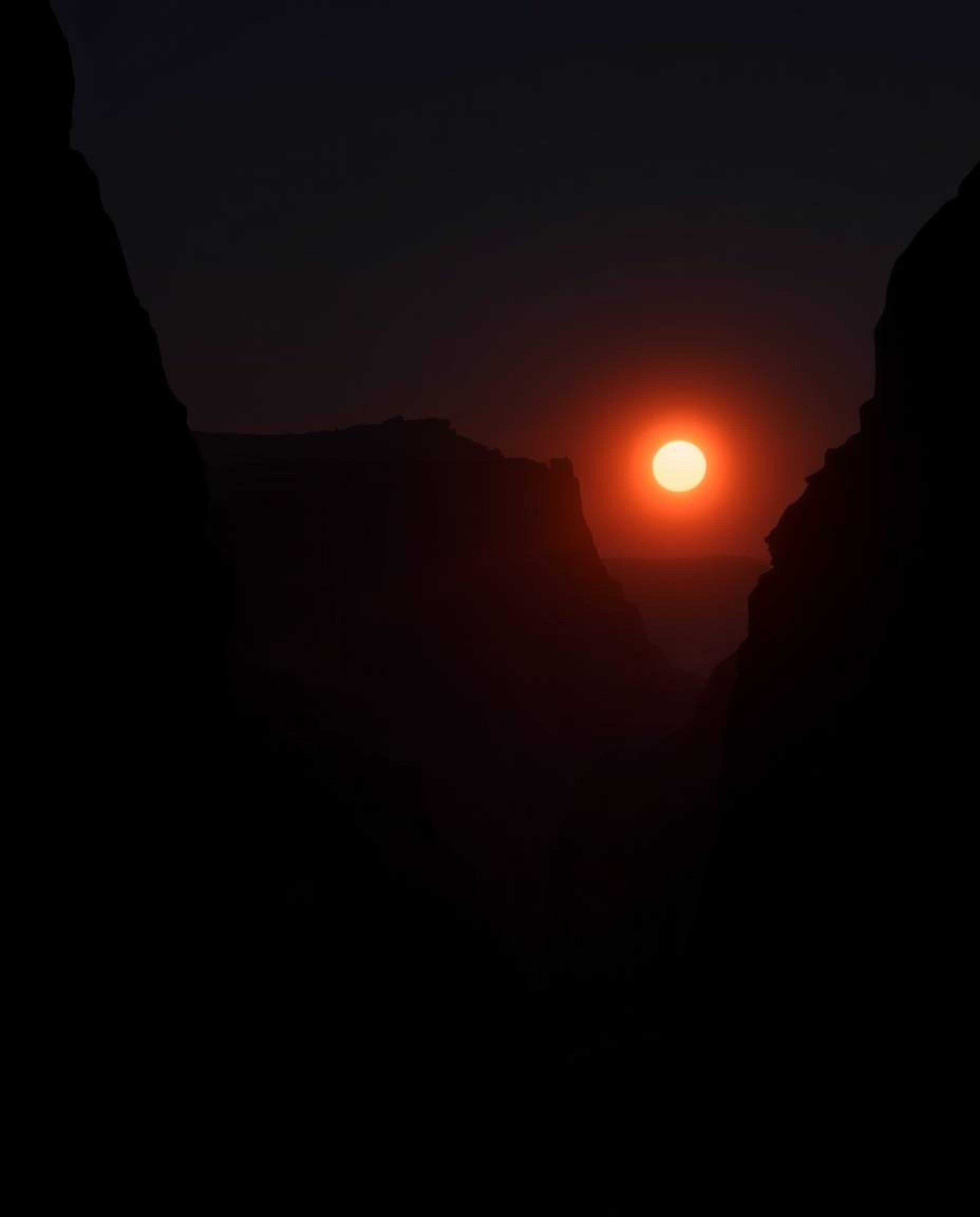 An extreme macro close-up, professional fine art photograph features soft, warm light illuminating sandstone cliffs at sunset