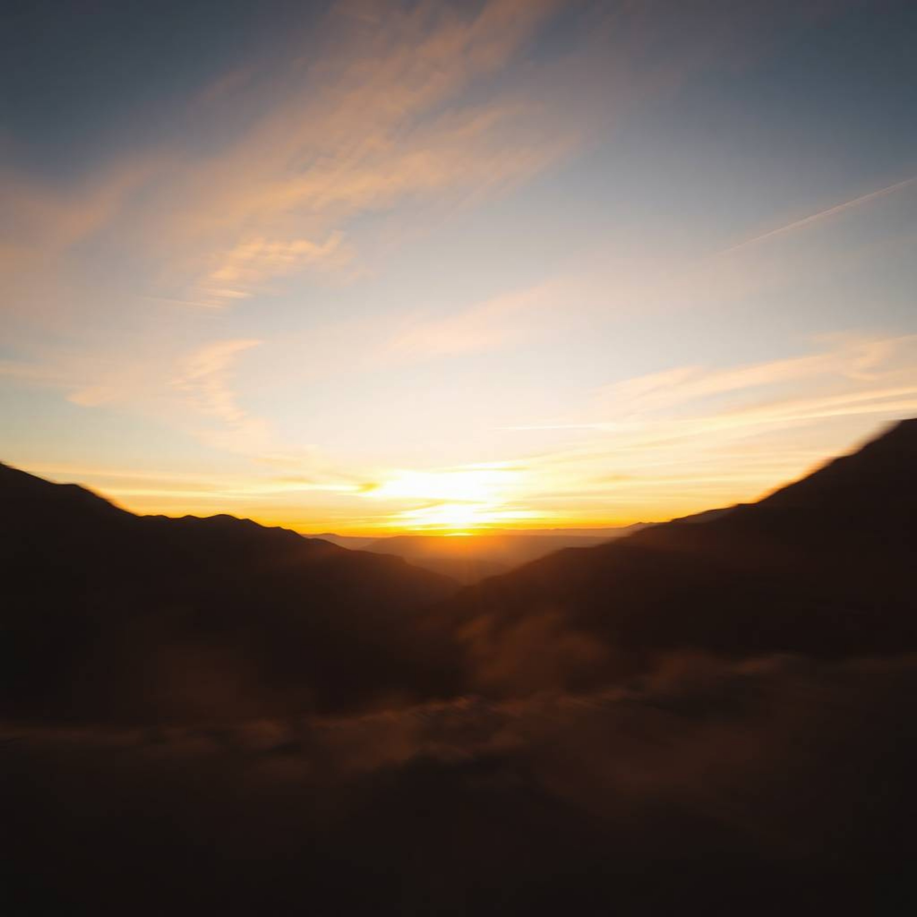 Experience the breathtaking beauty of a dynamic sunset over a serene mountain valley.  Volumetric lighting illuminates the sc