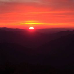 Capture the breathtaking beauty of a sunset over a tranquil mountain valley.  Experience the vibrant colors of red, orange, a