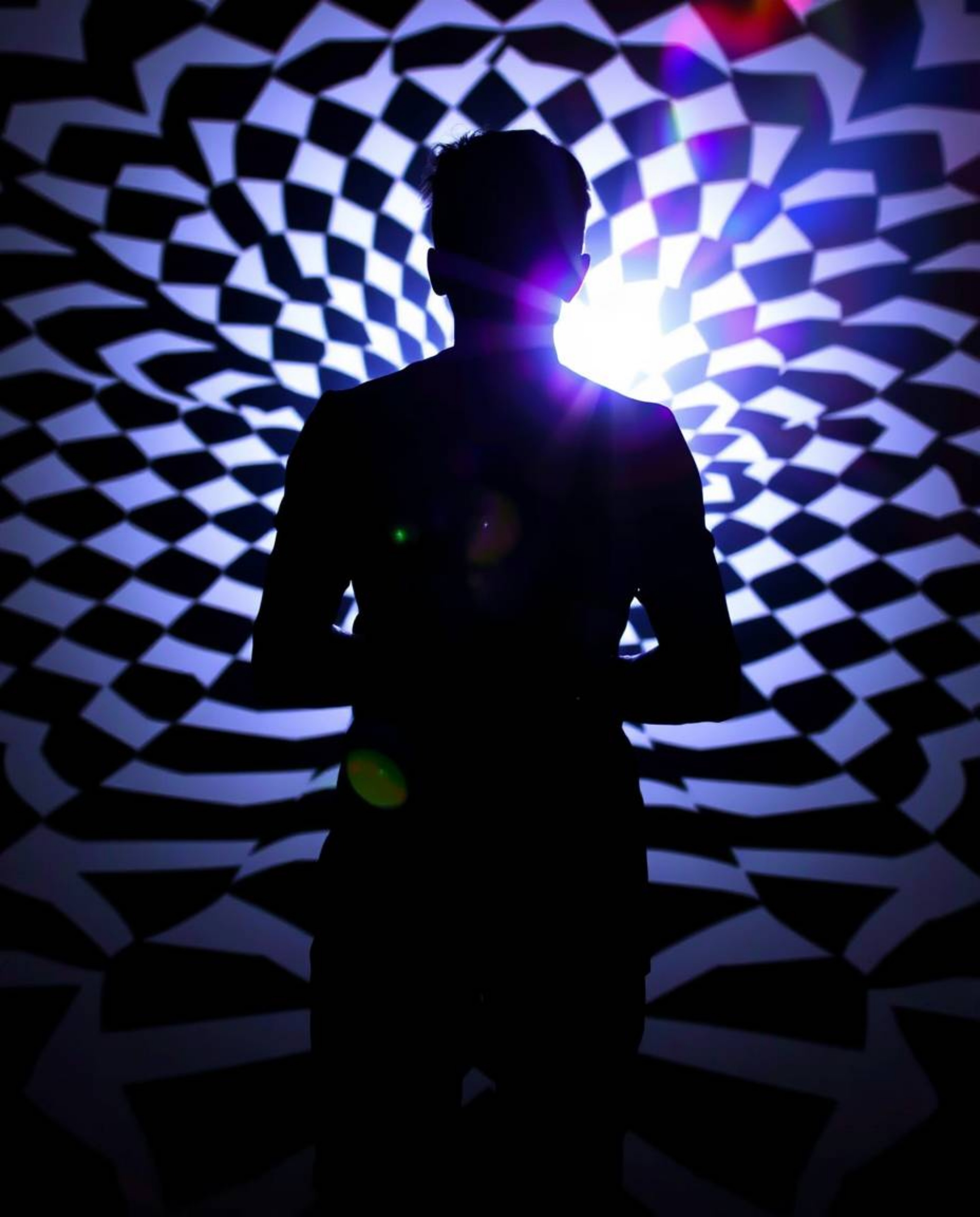 Explore the captivating allure of a silhouetted figure set against a striking black and white geometric pattern, enhanced by 