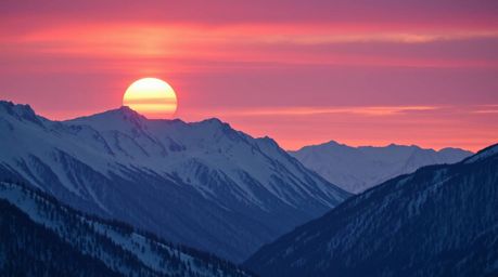 Capture the serene beauty of snow-covered mountains bathed in the warm glow of a pastel sunset.  This image showcases a sophi