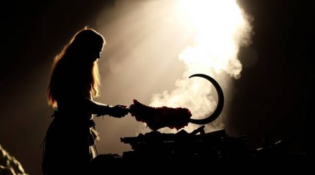 This striking image captures a silhouetted caveman expertly cooking mammoth meat, bathed in a brilliant backlight that emphas
