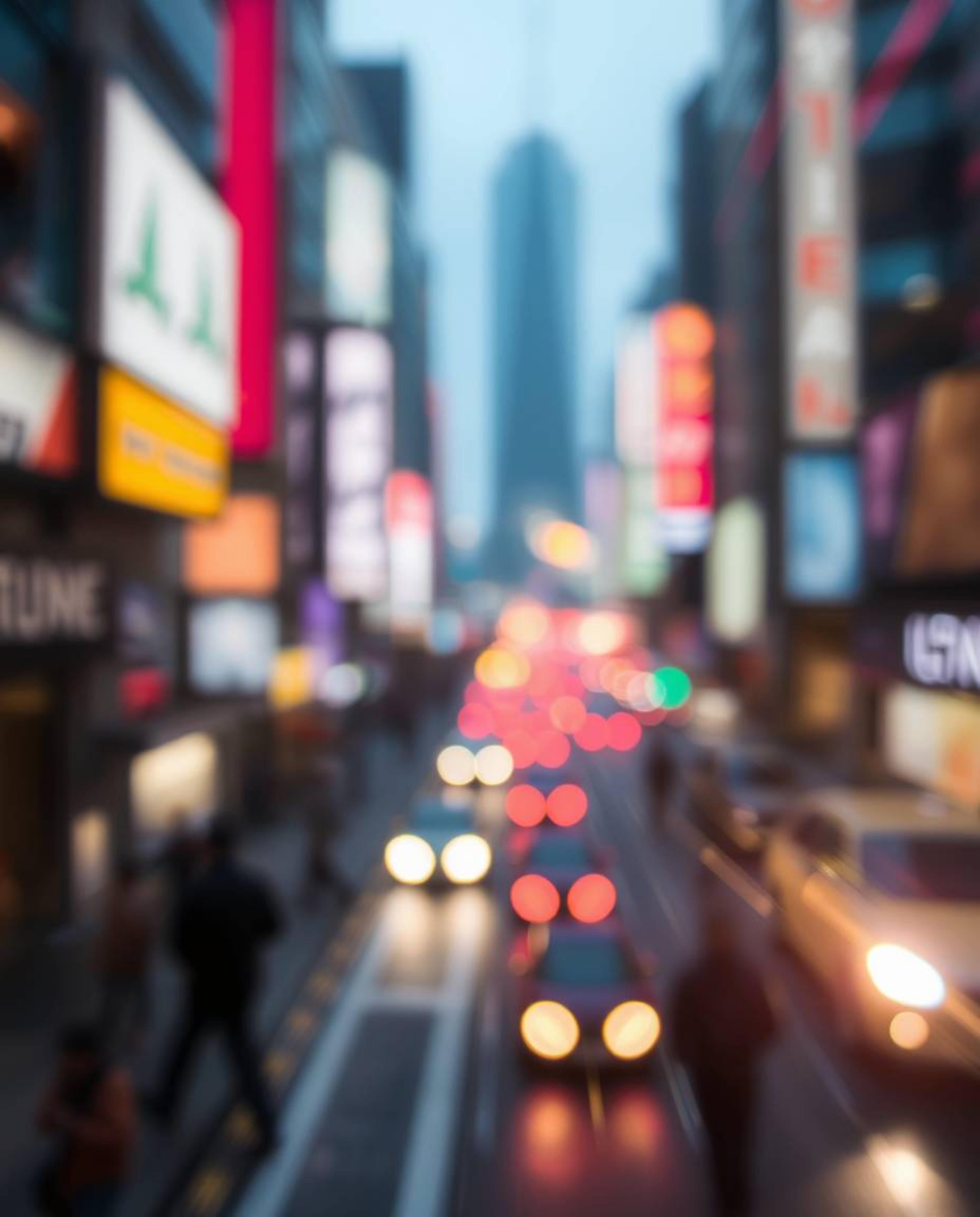 Immerse yourself in a vibrant futuristic cityscape, captured with a bright lens flare and blurred bokeh effect.  Experience t