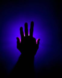 A captivating image featuring a hand reaching from darkness toward a light source, rendered in deep ultraviolet hues and vivi