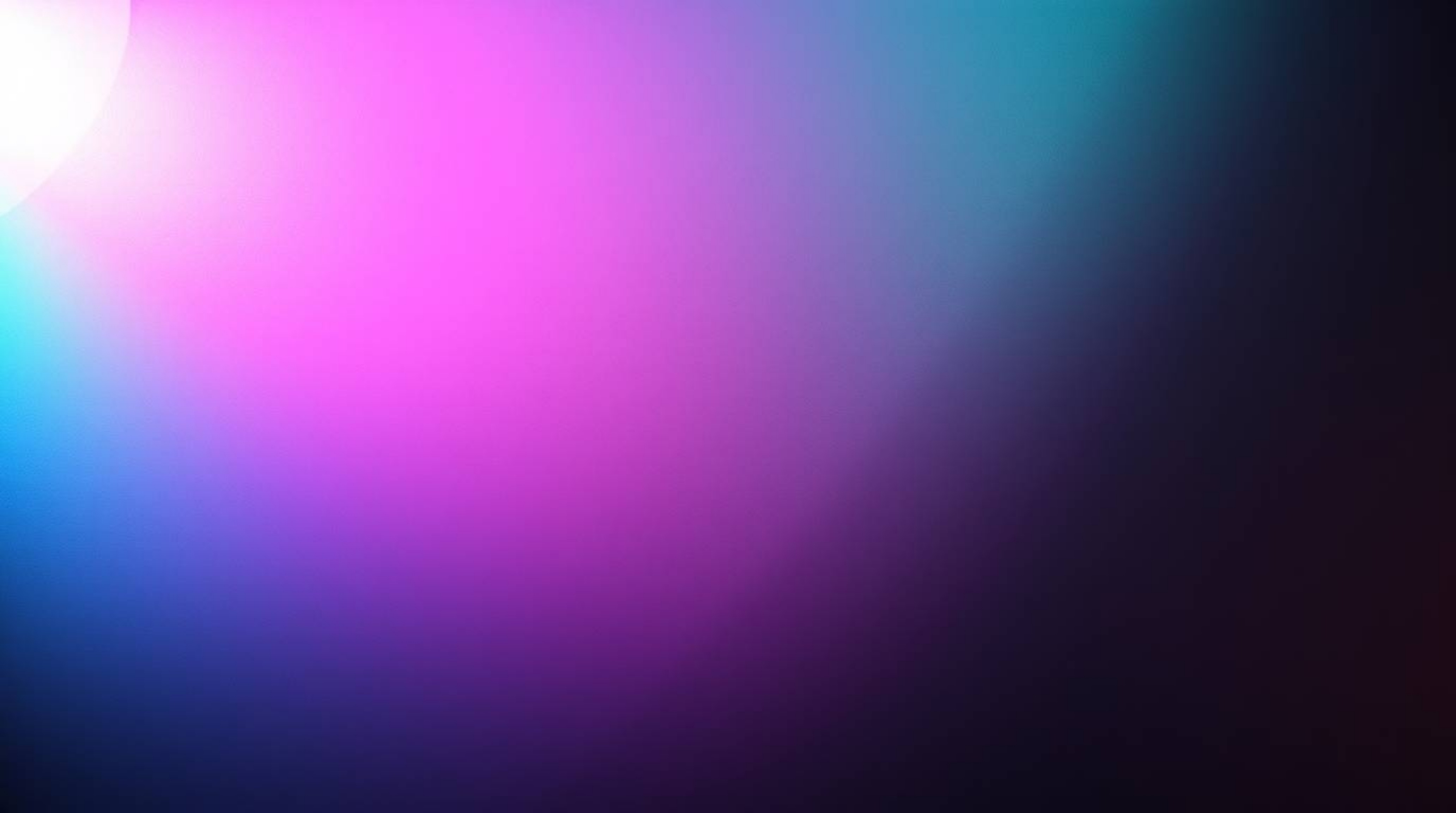 High contrast, low-key lighting illuminates an iridescent gradient texture on a metallic surface, creating vibrant color shif