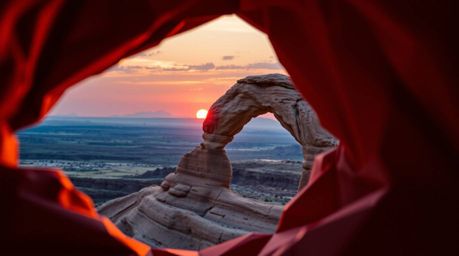 Experience the breathtaking beauty of a sunset captured through a desert rock arch, meticulously styled as intricate origami.