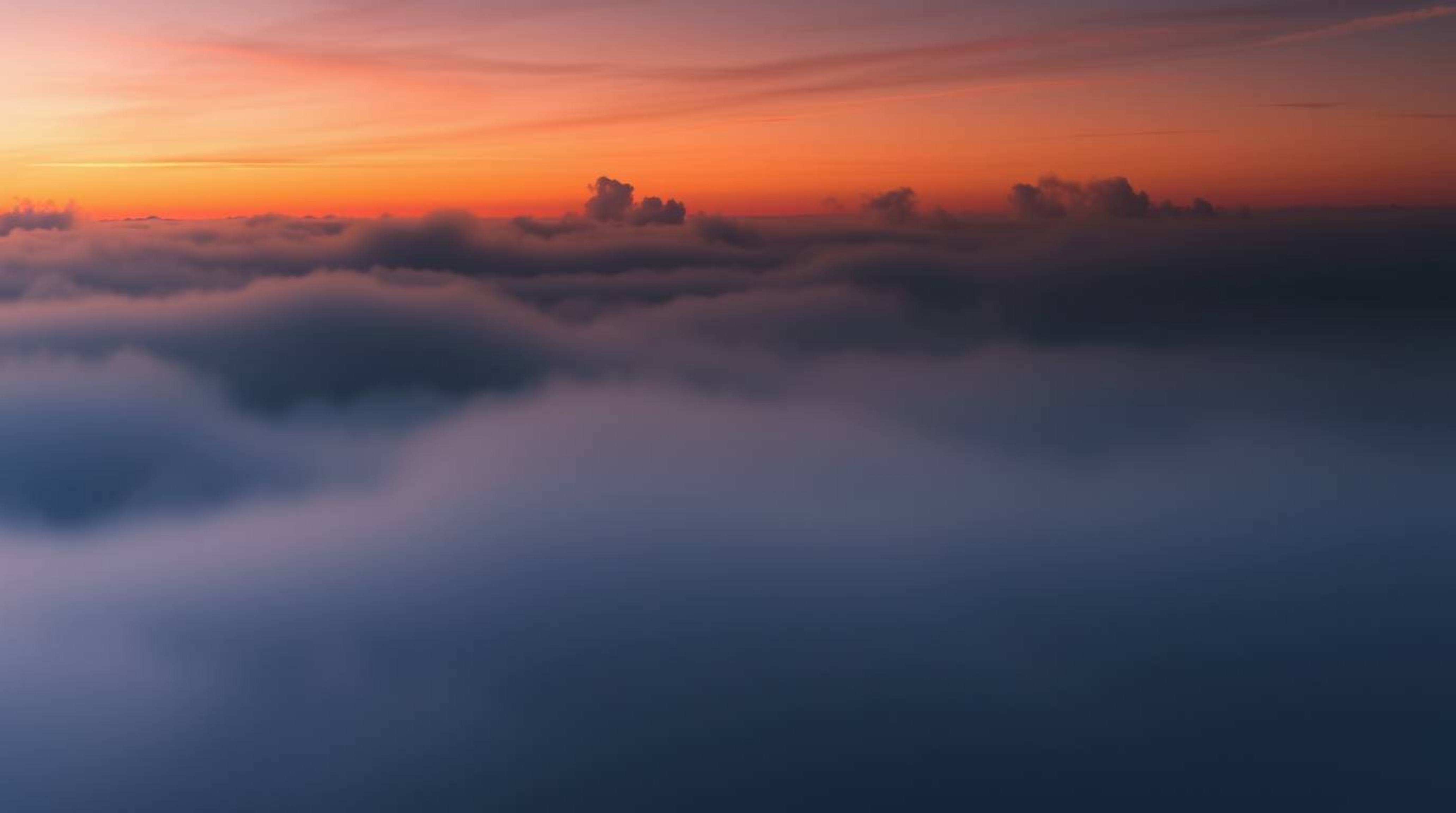 This image showcases a high-contrast scene of intense jet black, thick fog, and low visibility, contrasted against a beautifu