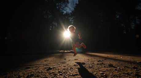 Experience a visually stunning and dramatic slow-motion run through a playground, characterized by strong, hard lighting and 