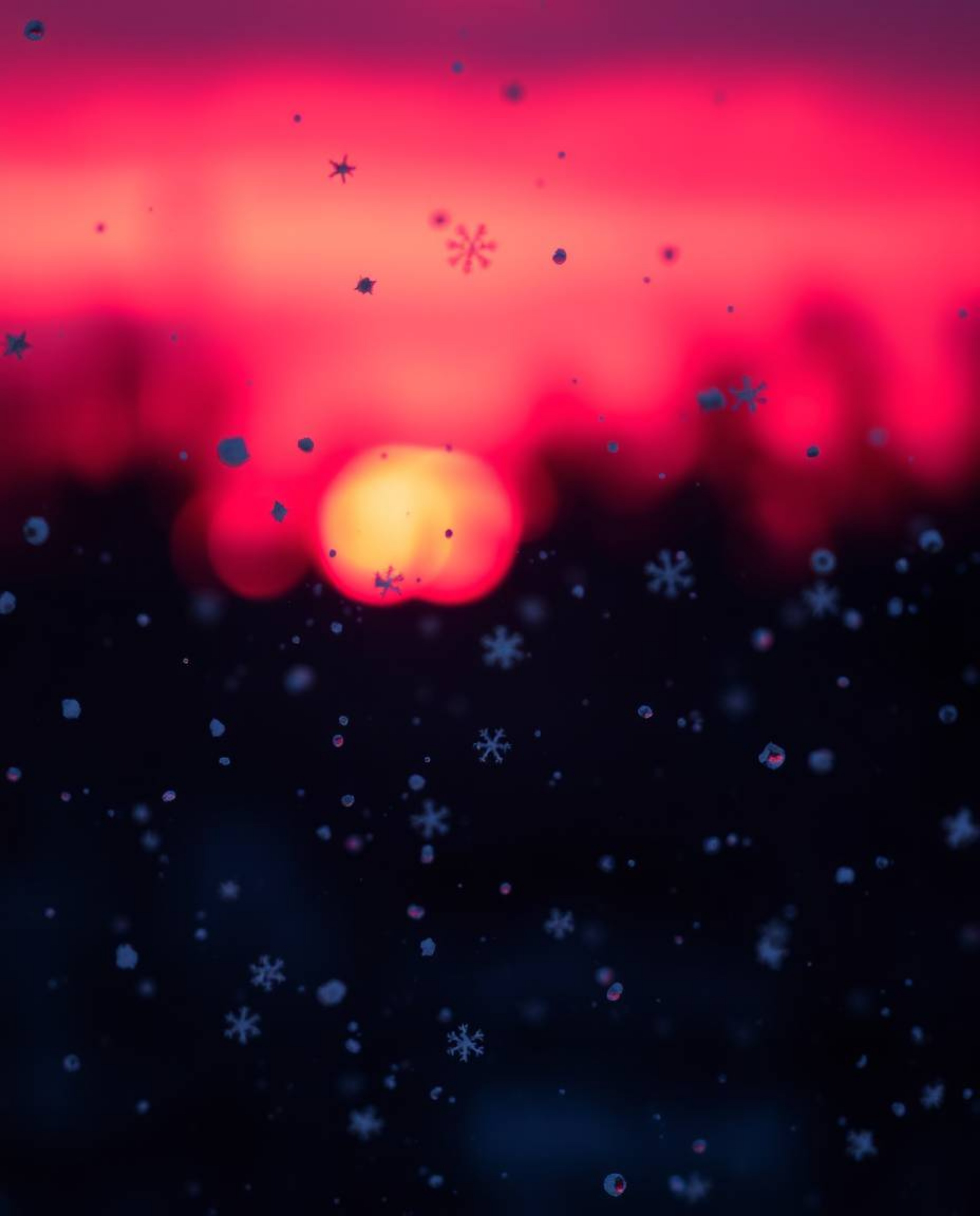 This high-contrast image captures snowflakes falling during a vibrant sunset. The scene is illuminated with a unique palette 