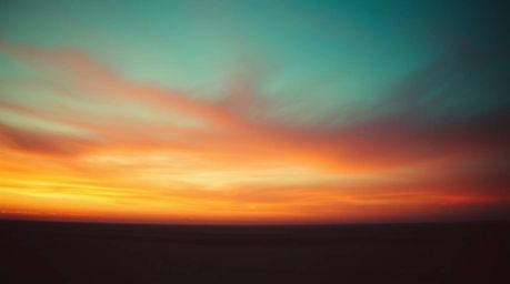 A captivating cinematic image blends warm terracotta and cool teal tones, showcasing a gradient sunset sky.  The soft, dreamy