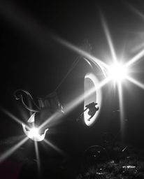 A captivating classic black and white image depicts a magical pumpkin transforming into an elegant carriage.  Bright lens fla