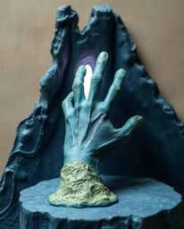 Discover stunning sculptural clay art depicting a hand reaching towards light from darkness.  This piece evokes a sense of ho