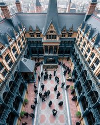 A stunning overhead architectural photograph captures a magical school brimming with young wizards.  The image showcases shar
