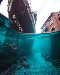 Discover a captivating underwater shipwreck captured in a unique street photography style.  Surreal infrared tones create an 