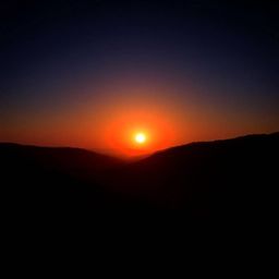 Experience the breathtaking beauty of a fine art photograph capturing a serene sunset over a quiet mountain valley.  This ima