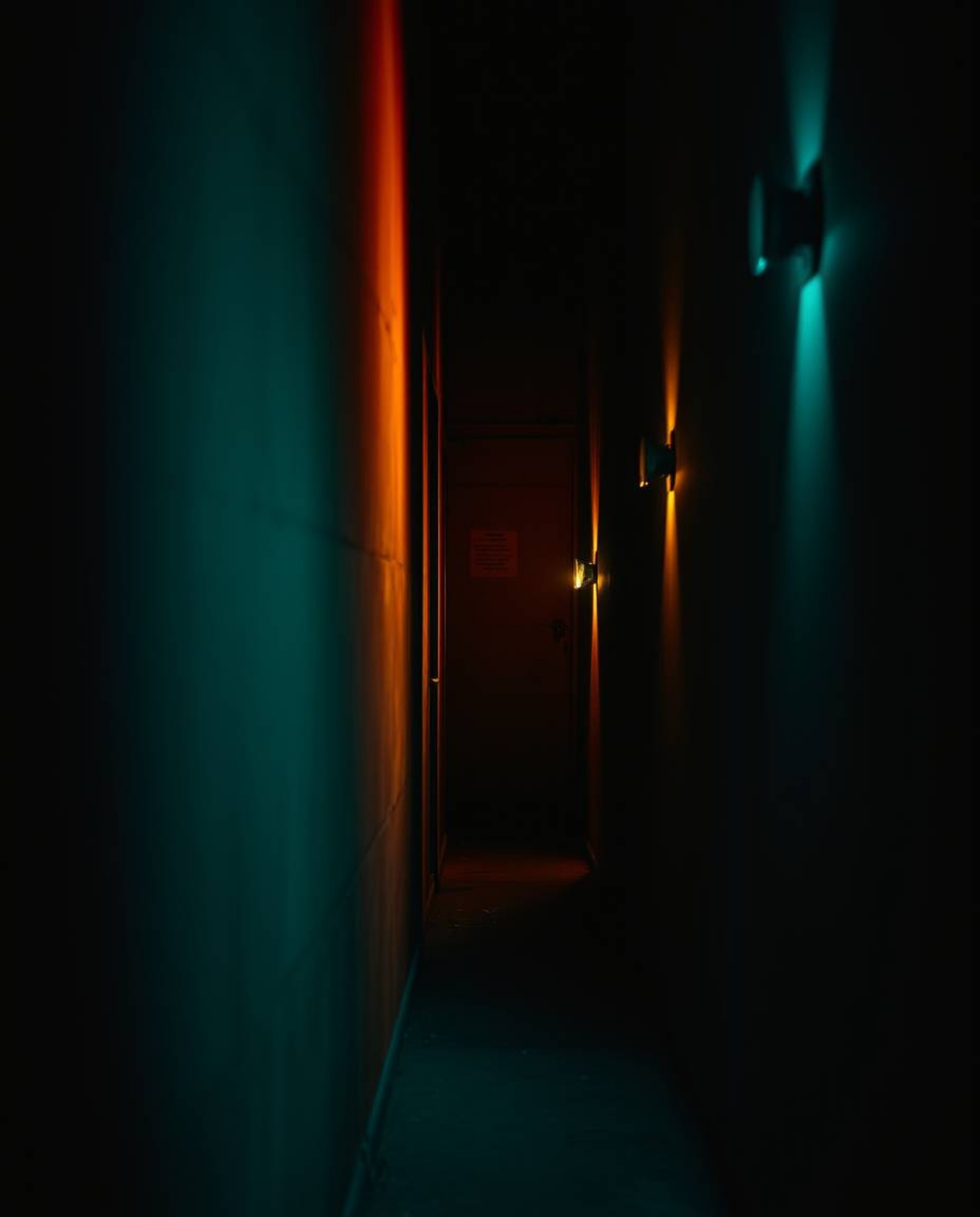 Explore the dramatic interplay of high contrast low key lighting, featuring warm terracotta and cool teal tones, as eyes watc