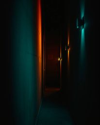 Explore the dramatic interplay of high contrast low key lighting, featuring warm terracotta and cool teal tones, as eyes watc