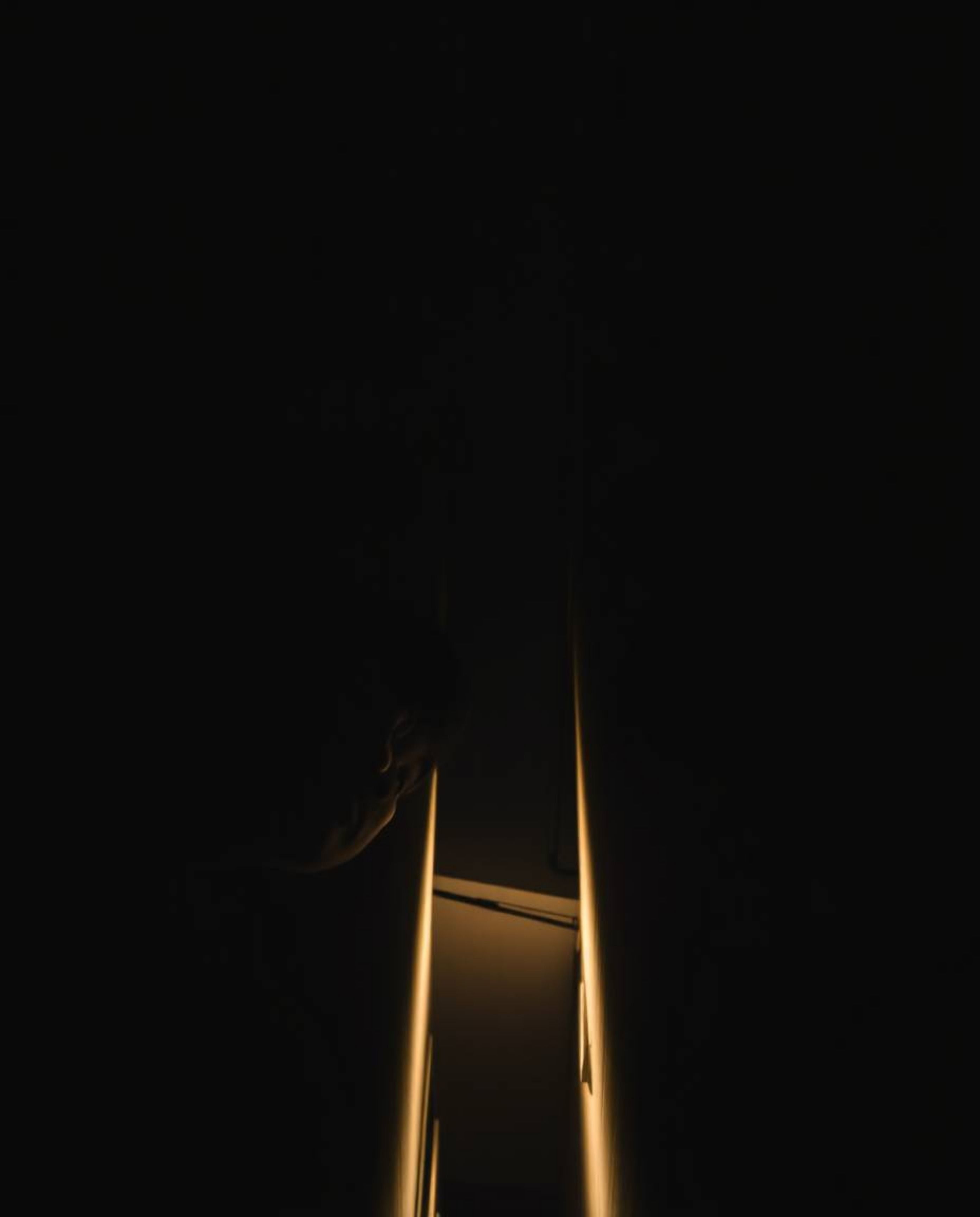 A captivating image captures the essence of mystery and suspense, showcasing eyes peering upward from the dark shadows of an 