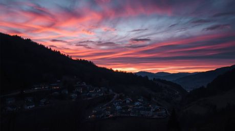 Discover a captivating high-contrast photograph of a cozy village nestled in a picturesque valley.  The image showcases a vib