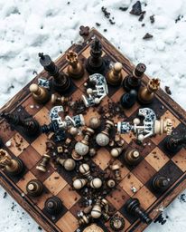 This image presents a bird's eye view of a chessboard locked in a state of dramatic destruction. Pieces are frozen mid-air, c