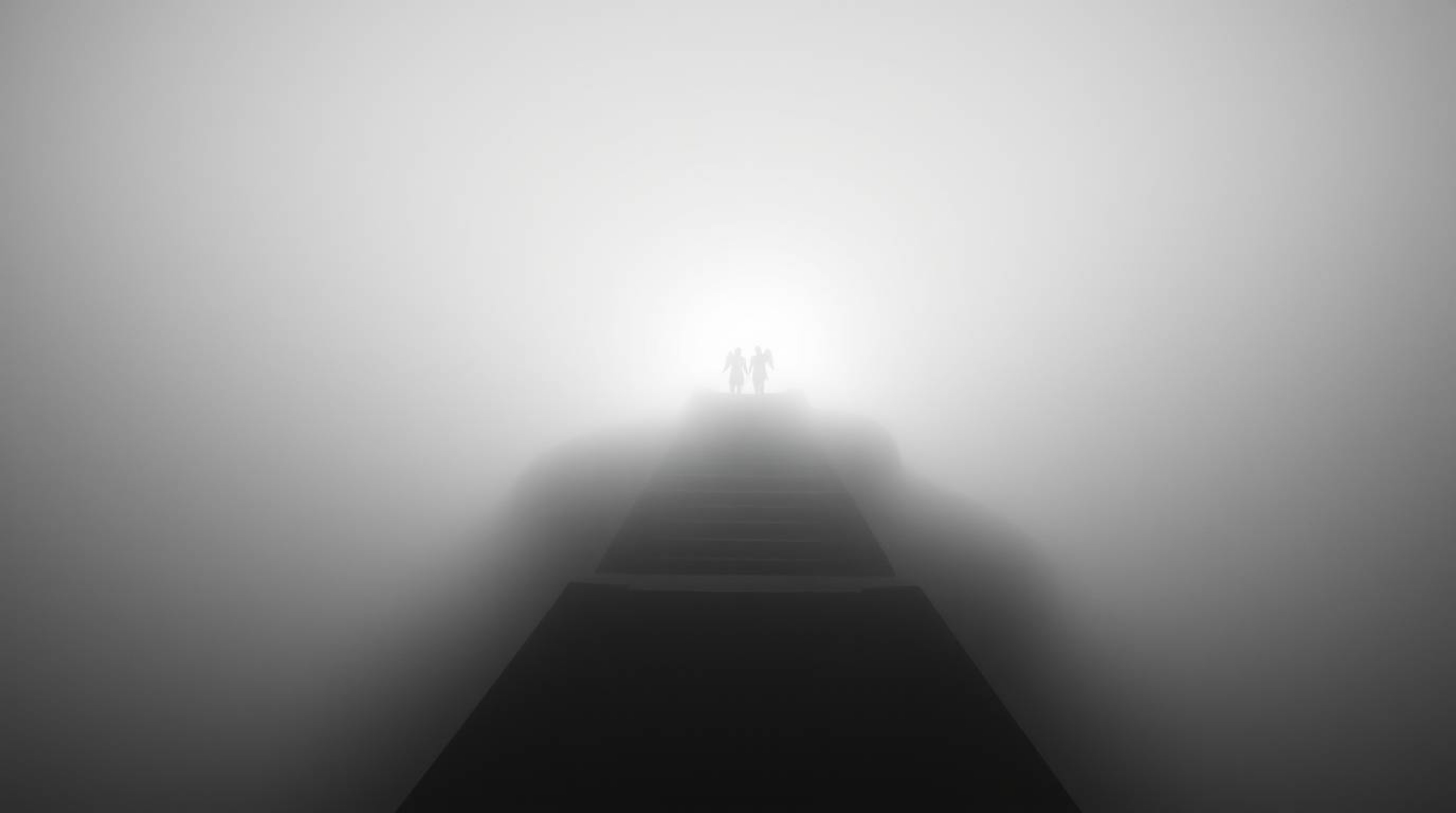 High-angle view black and white photograph featuring steps of light ascending into a foggy sky, creating a dreamlike and peac