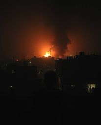 An eerie and moody fine art photograph depicting a city consumed by flames, with people desperately fleeing in all directions