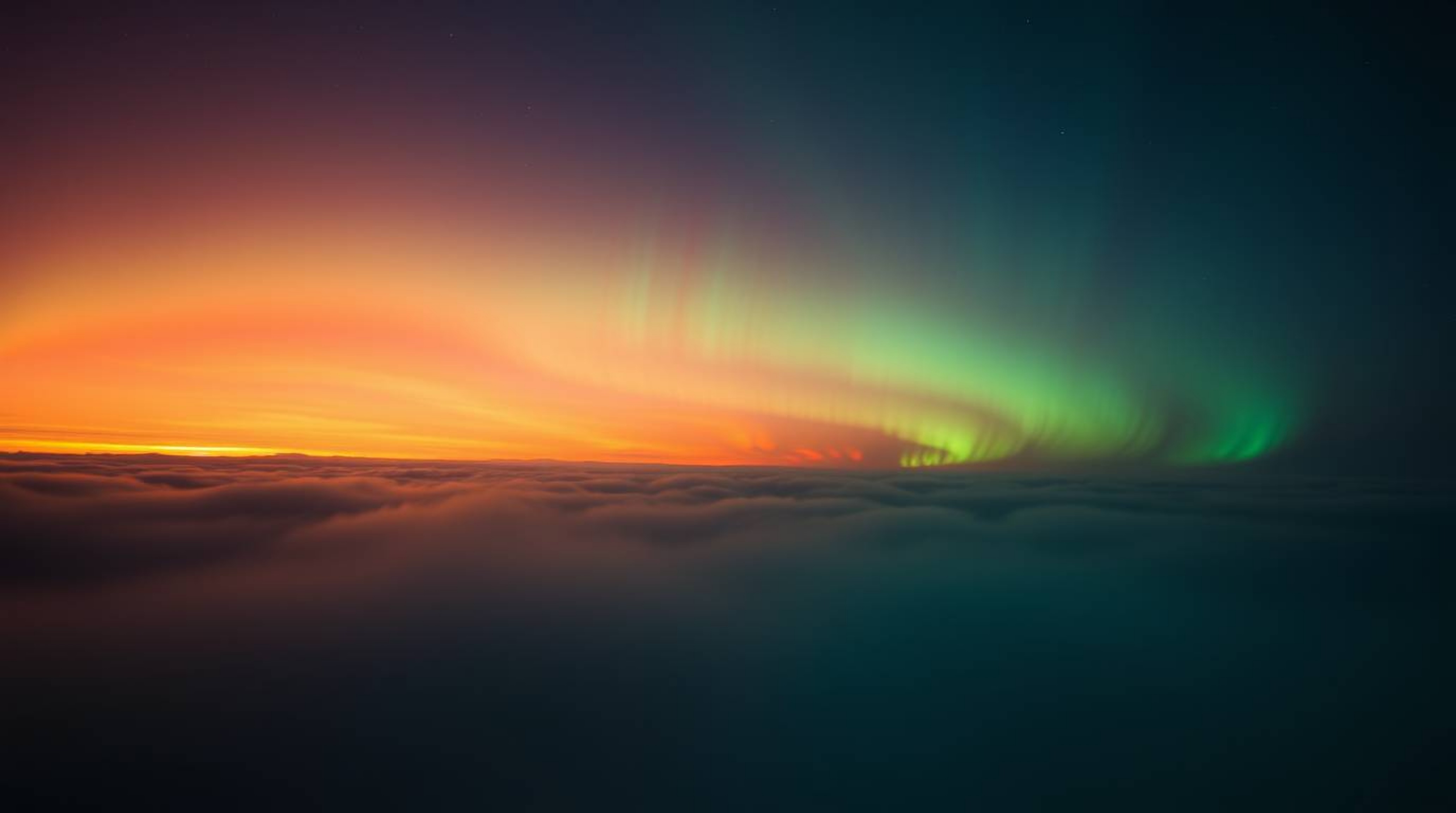 Witness the breathtaking spectacle of the Northern Lights emerging over a vibrant sunset sky.  This captivating image showcas