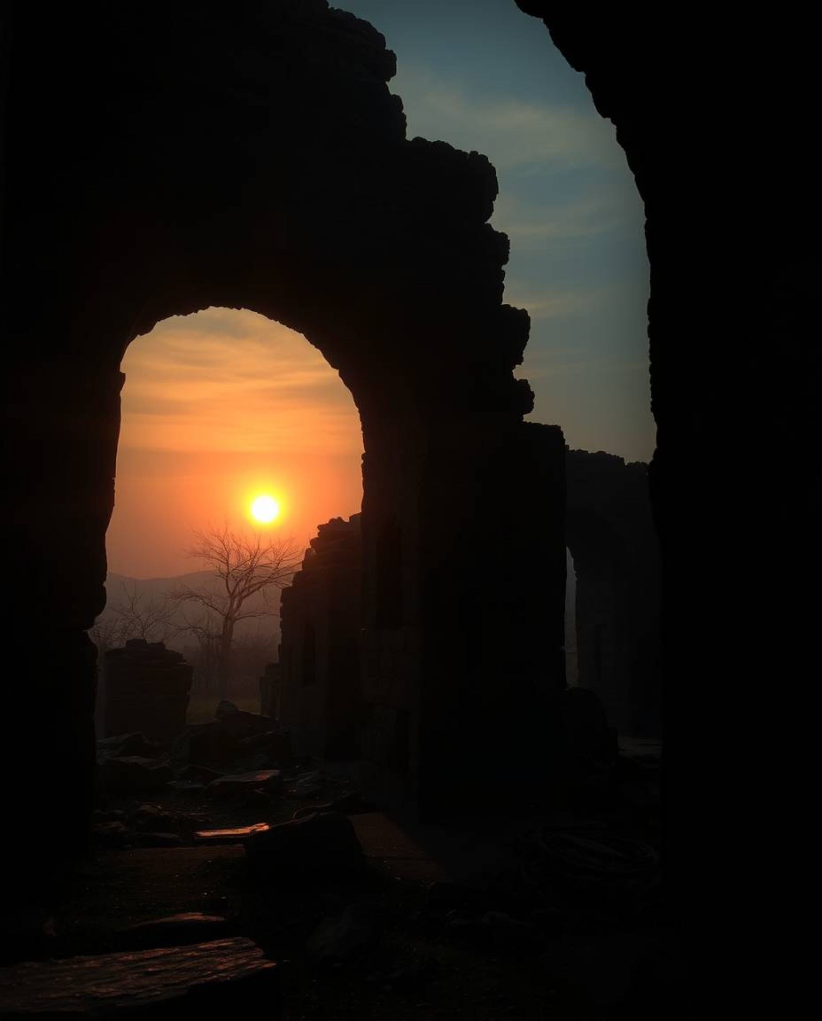 An eerie and creepy atmosphere pervades a scene where a sunset casts shadows through ancient stone ruins. This mystic and enc