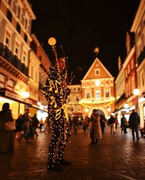 A creative light art piece depicting a musical number performed in a bright town square. The artwork incorporates artistic li