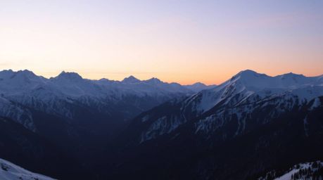 Experience the breathtaking beauty of snow-capped mountains bathed in the soft glow of a pastel sunset.  Gentle light creates