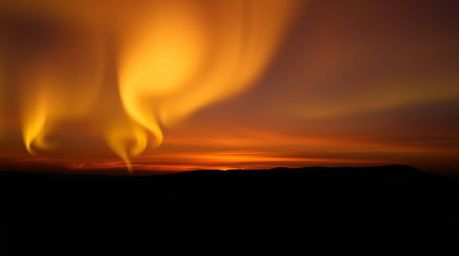 Experience the breathtaking beauty of the Northern Lights dancing across a vibrant sunset sky. This artistic lighting piece f