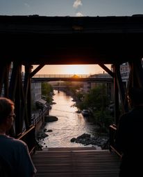 An extreme macro close-up captures the intricate details of an old wooden bridge over a river at sunset. The image is rendere