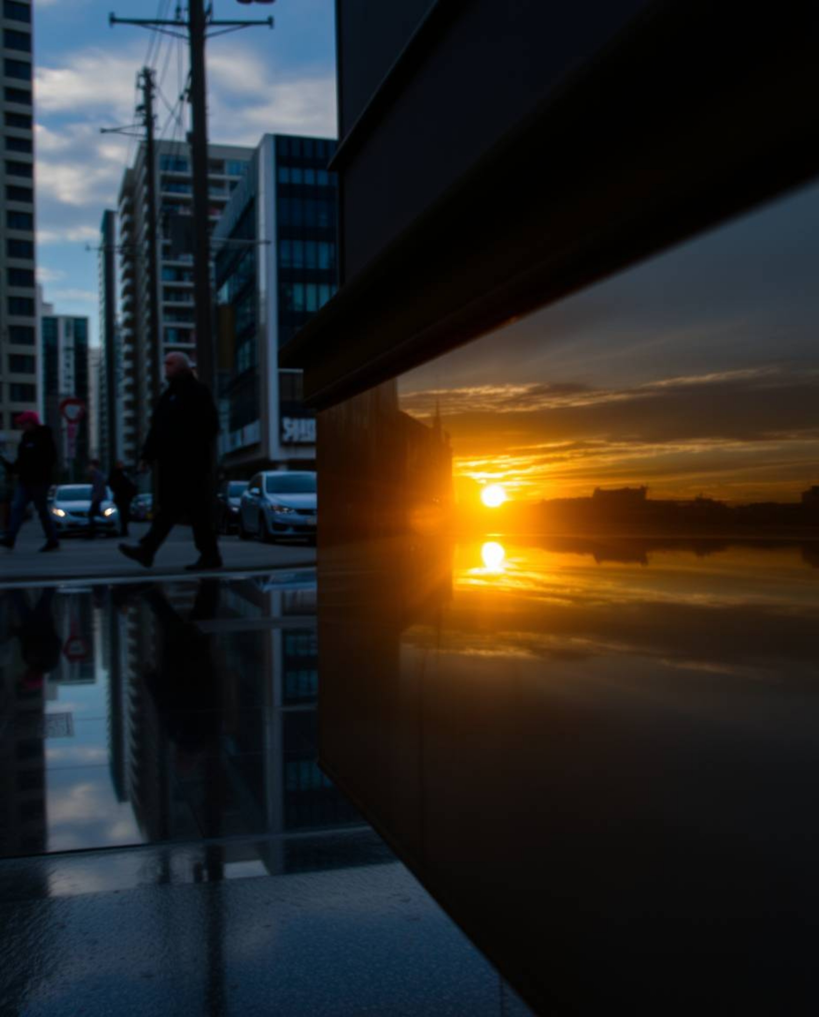 A compelling candid street photograph capturing a spontaneous moment: the reflection of a stunning sunset in a glassy fjord, 