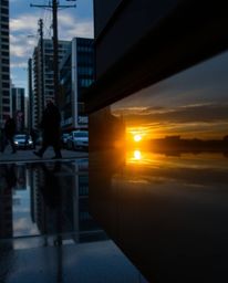 A compelling candid street photograph capturing a spontaneous moment: the reflection of a stunning sunset in a glassy fjord, 