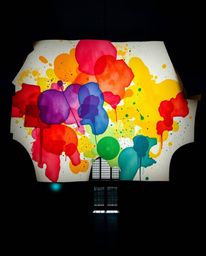 A precise architectural color photograph featuring silhouetted backlighting that beautifully highlights colorful watercolor s