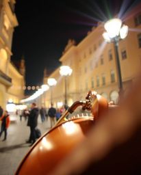 This image showcases an extreme macro close-up of a vibrant musical number unfolding in a brightly lit town square. The focus