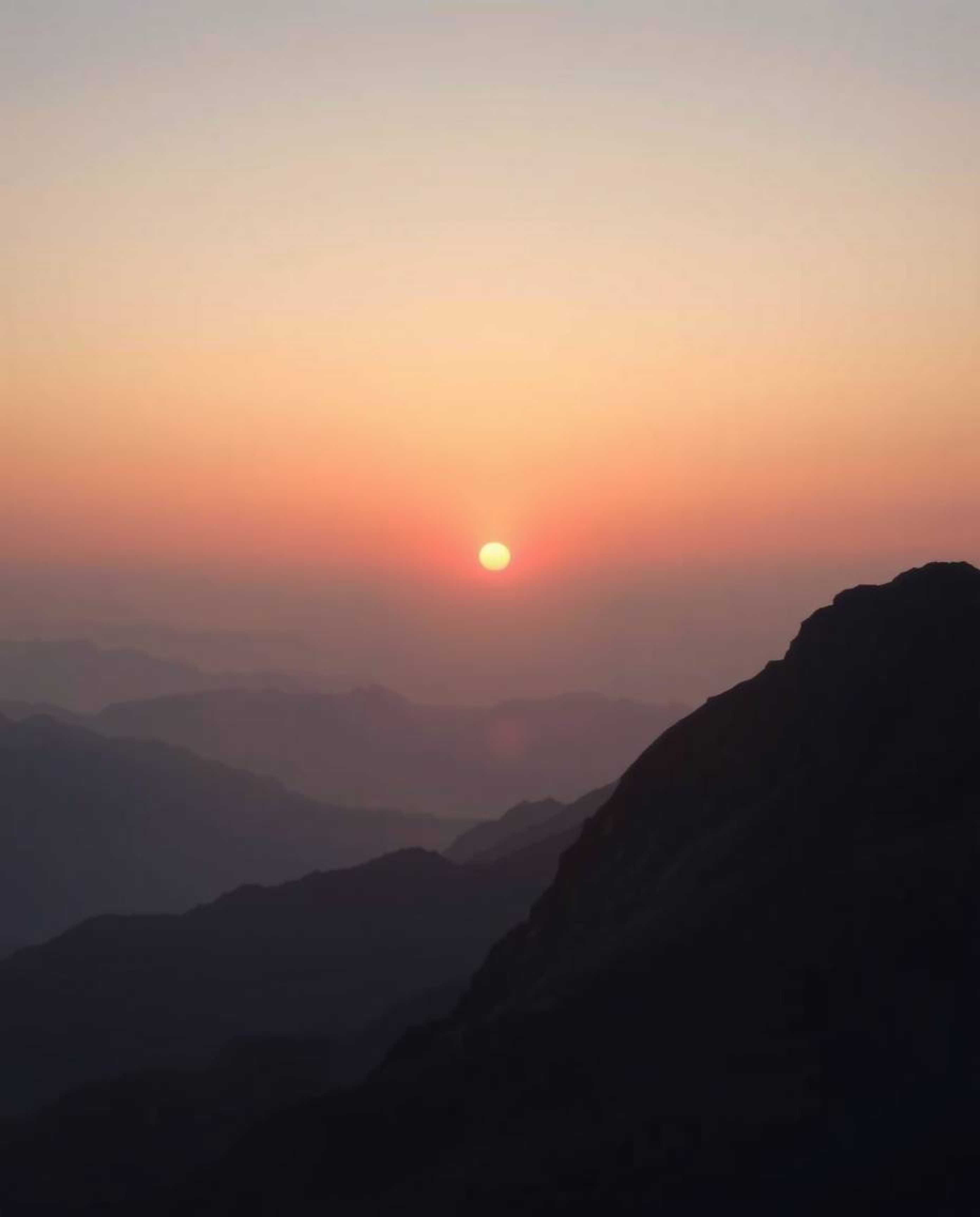 This is a soft cinematic image of a sunset viewed from a high alpine peak, rendered in delicate soft pastel colors to create 