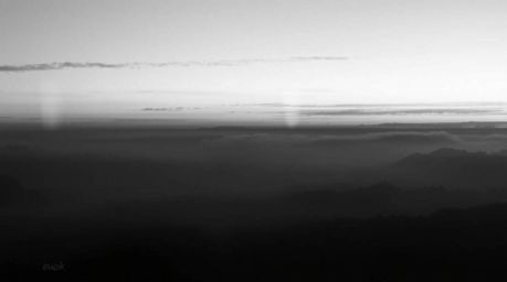 Capture the timeless elegance of a classic black and white photograph featuring the ethereal Northern Lights dancing across a