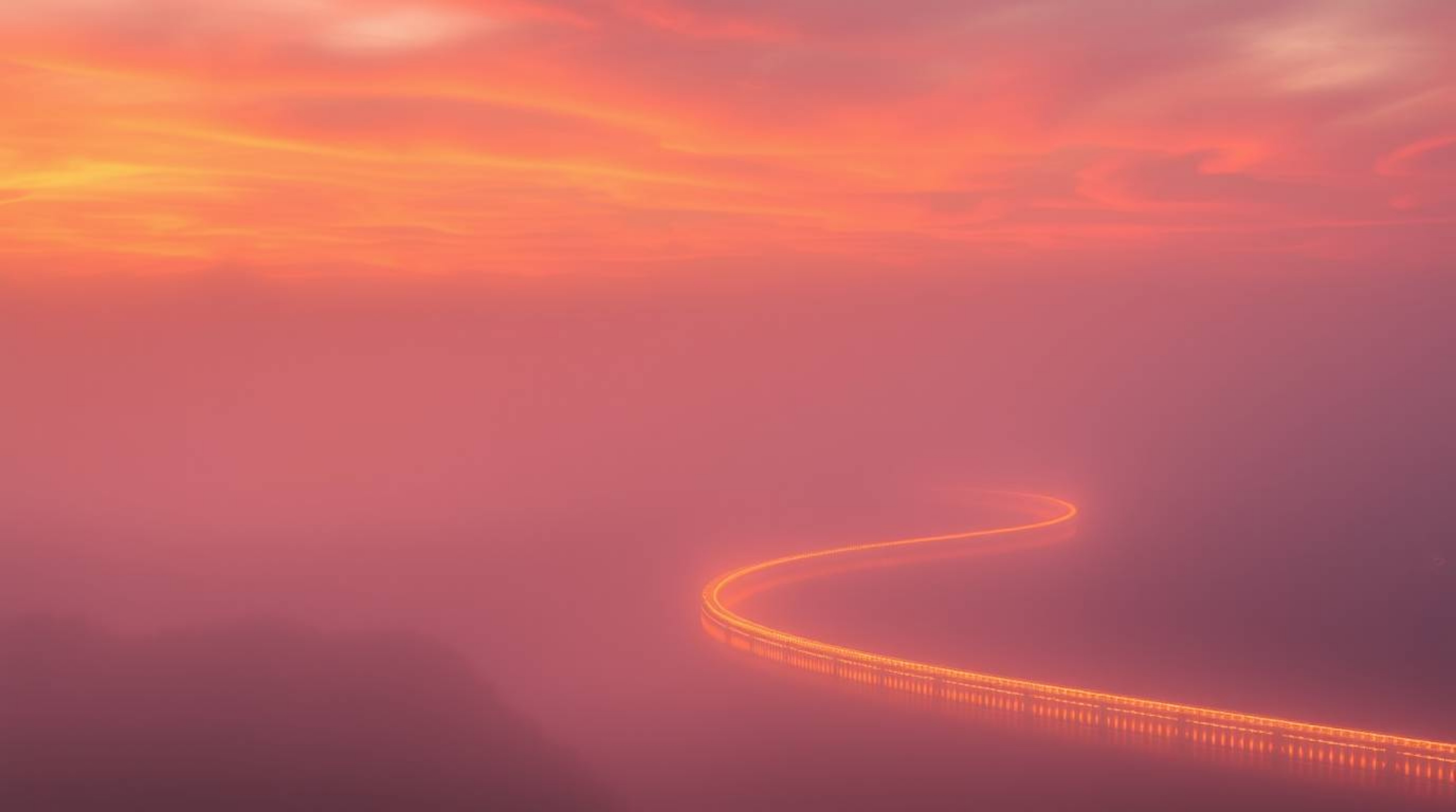 A professional fine art photograph capturing a winding river illuminated under a dramatic orange-pink sky, shrouded in thick 