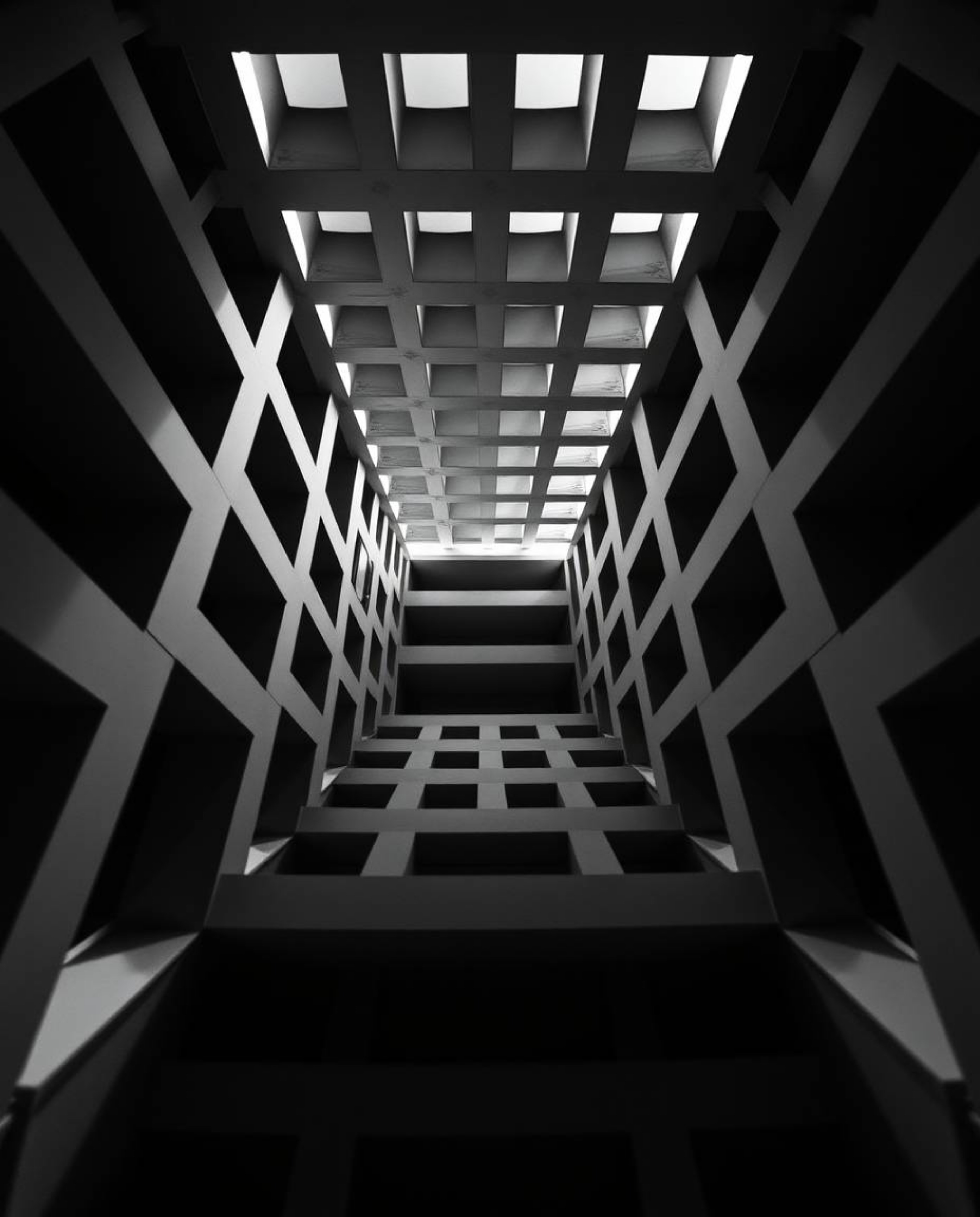 A timeless, elegant black and white photograph showcasing a repetitive cube pattern in the style of Escher's impossible geome