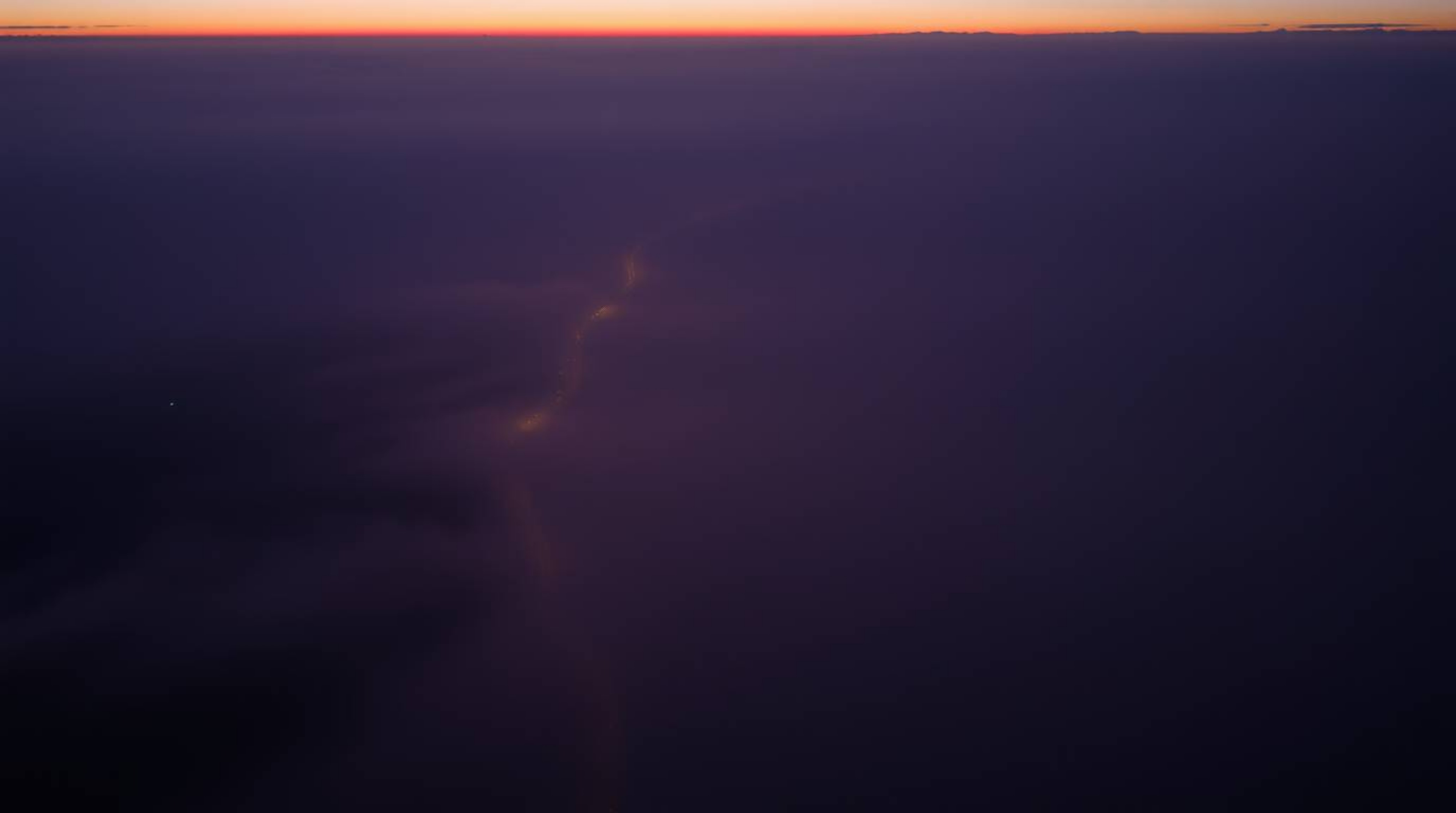 Experience the ethereal beauty of a river delta bathed in the soft glow of twilight. This high-angle perspective captures the