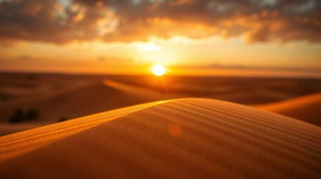 A captivating photograph showcases a mesmerizing sunset painting the golden desert dunes in hues of bronze. The antique patin