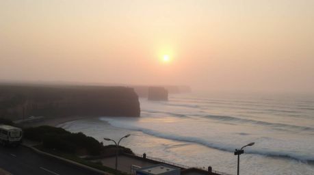 Candid street photography capturing a soft and dreamy atmosphere depicts waves crashing dramatically against cliffs under a h