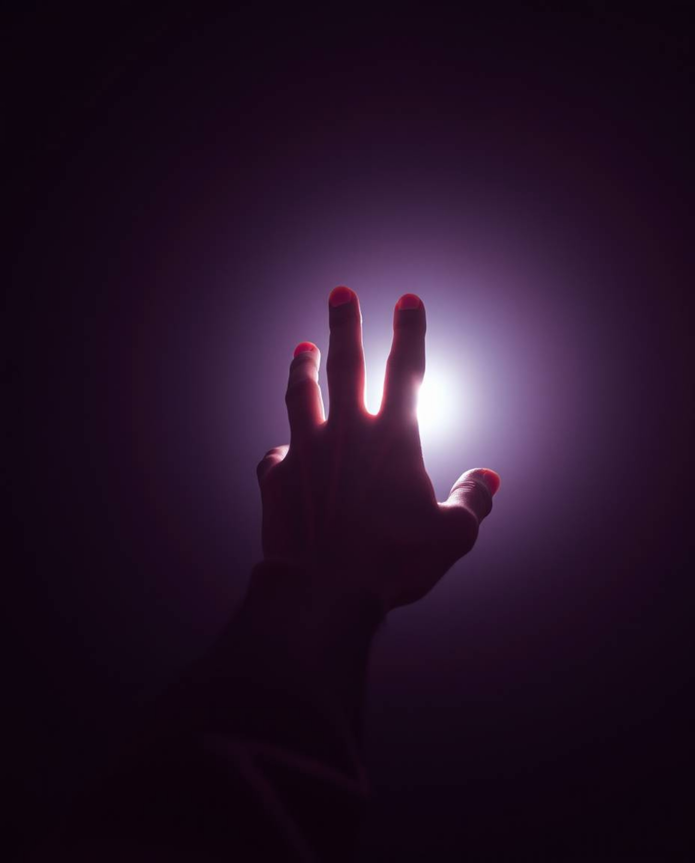 A captivating high-resolution stock photo depicts a hand emerging from darkness, yearning for a source of light.  Rendered in