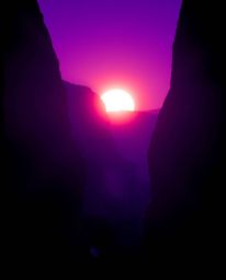 This image features dramatic silhouetted backlighting, capturing a sunset as it illuminates sandstone canyon cliffs. The scen
