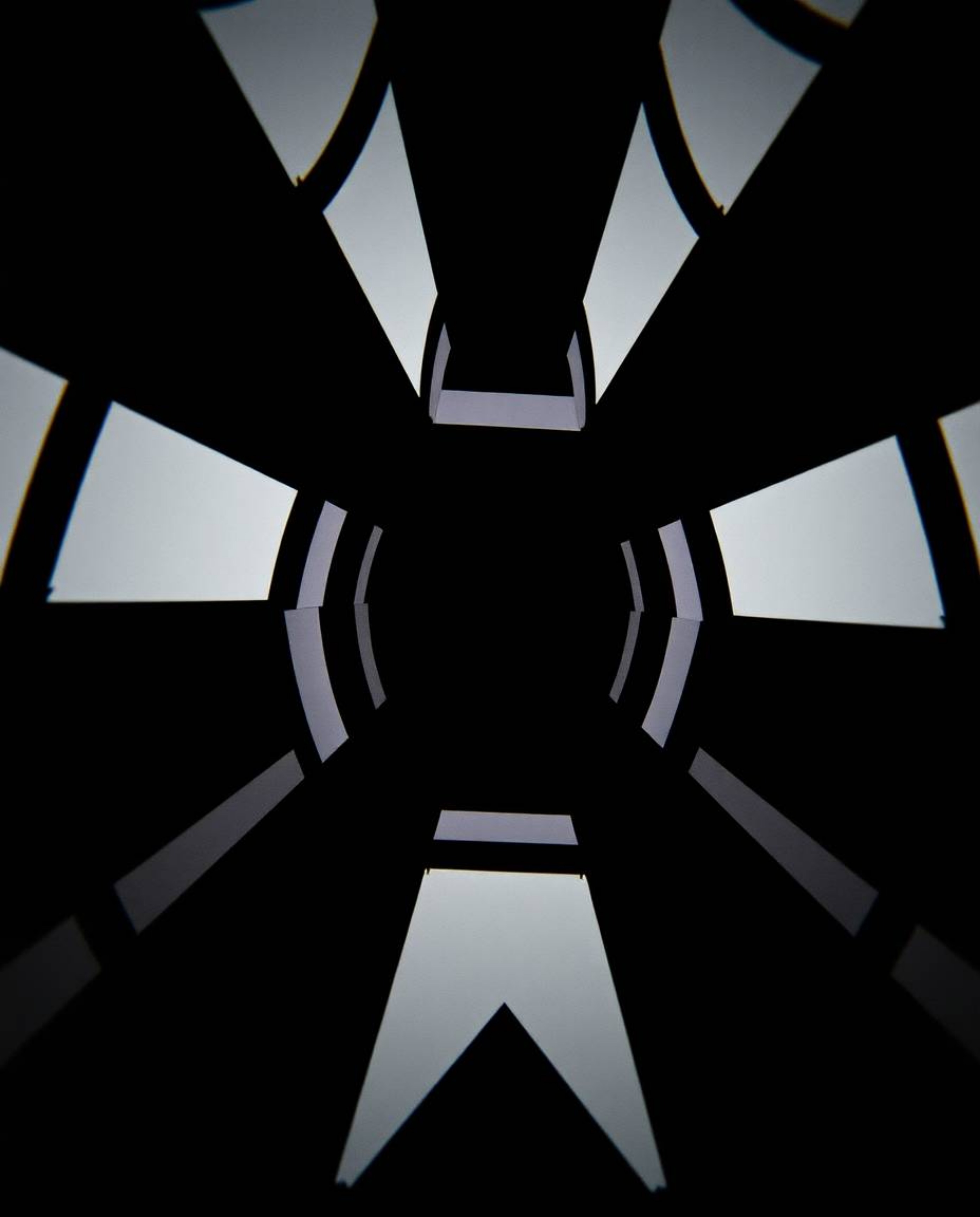 Immerse yourself in a captivating black and white geometric optical illusion pattern, rendered in a cinematic style with inte