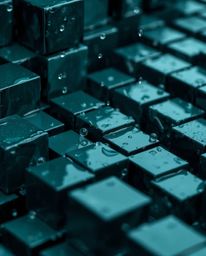 A captivating close-up photograph showcases a mesmerizing wet, rainy scene with rich, deep teal tones.  The image features a 