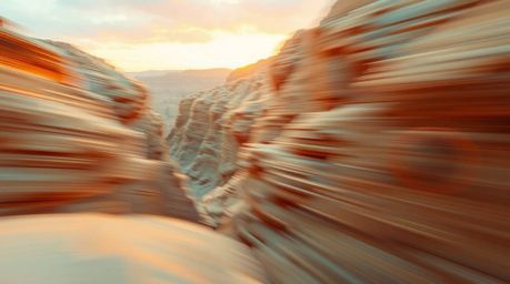 A captivating digital art piece depicts a rocky canyon bathed in the warm glow of a setting sun.  The soft pastel rendering e